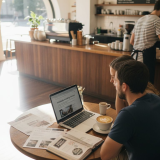 Couple reviewing wedding venues at Adelaide café