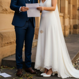 Couple checking wedding checklist outside venue