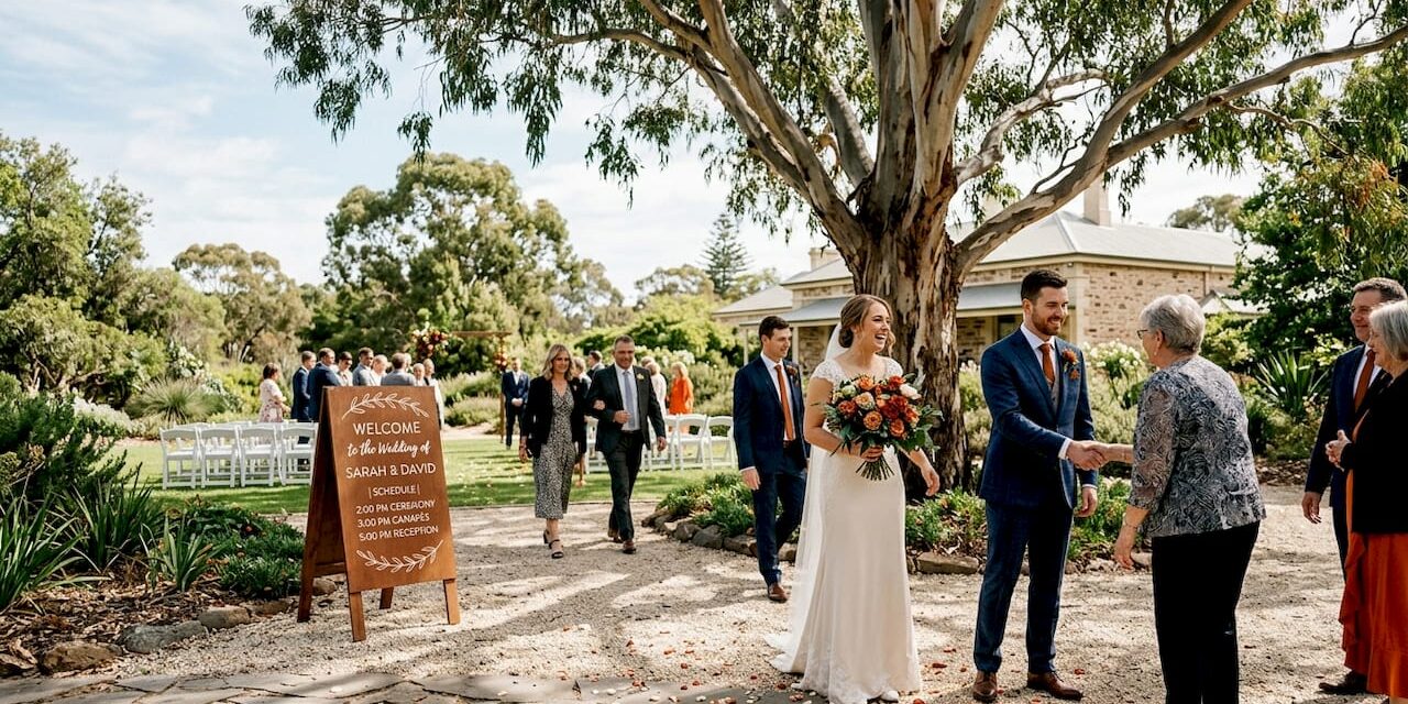 https://adelaideweddingvenues.com/new/wp-content/uploads/2026/05/1778149556218_Couple-greeting-guests-at-Adelaide-garden-wedding-venue-1280x640.jpeg
