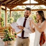 Couple inspecting event venue with checklist