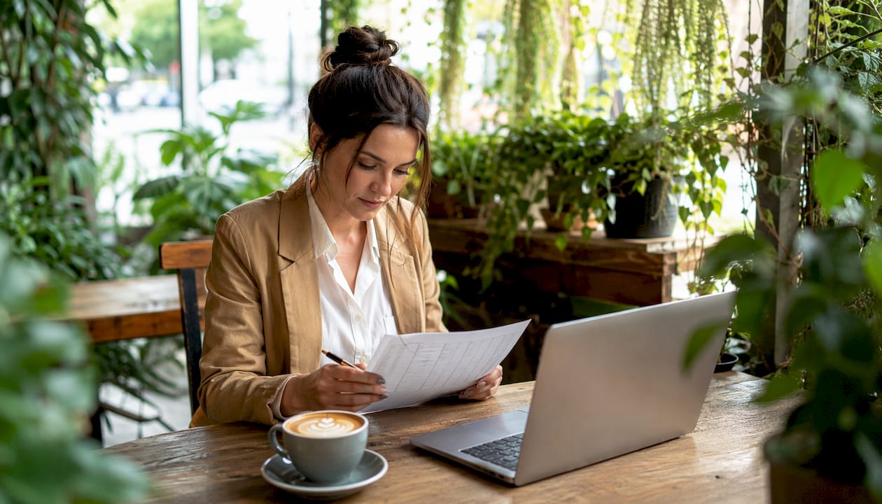 Venue comparison checklist for Australian couples 1 Woman planning wedding guest count in café
