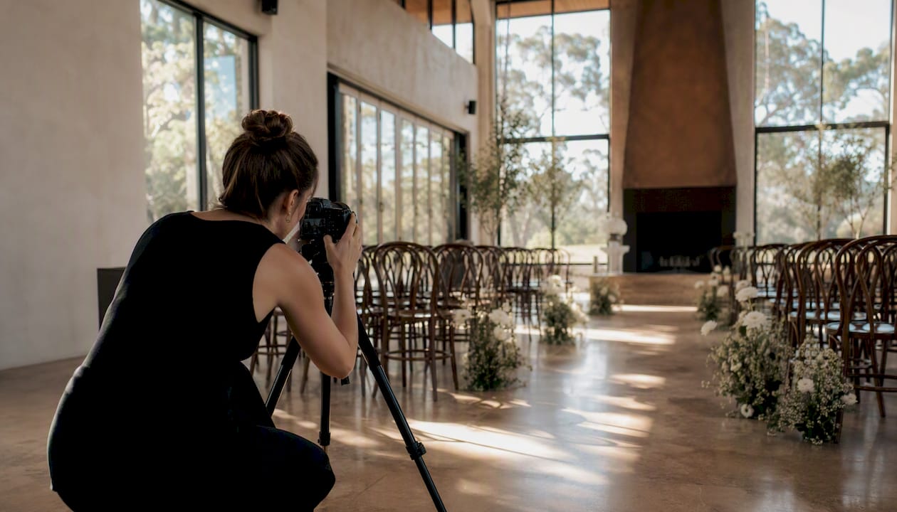 Why use a searchable wedding venue database in Adelaide 2 Photographer adjusting camera to capture natural light in venue