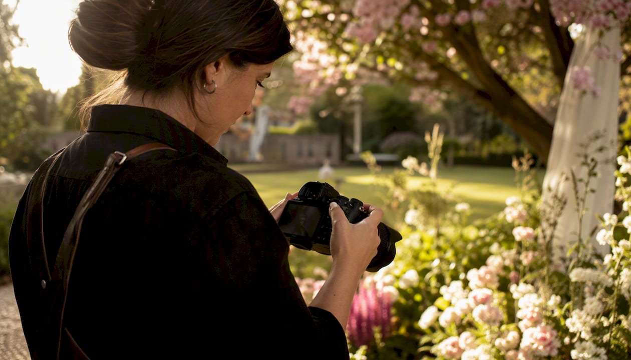 How image galleries shape listing performance for sellers 2 Photographer reviewing photos on camera at venue