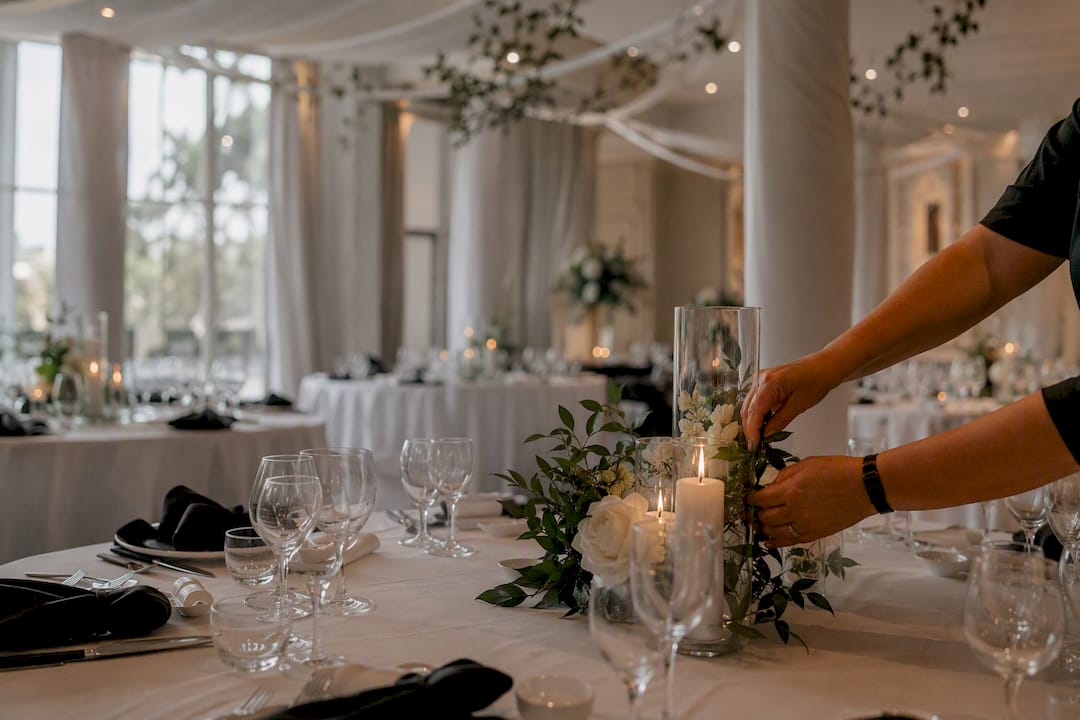 Small vs large venue: which size actually fits your wedding? 2 Wedding venue interior with pillars and catering setup