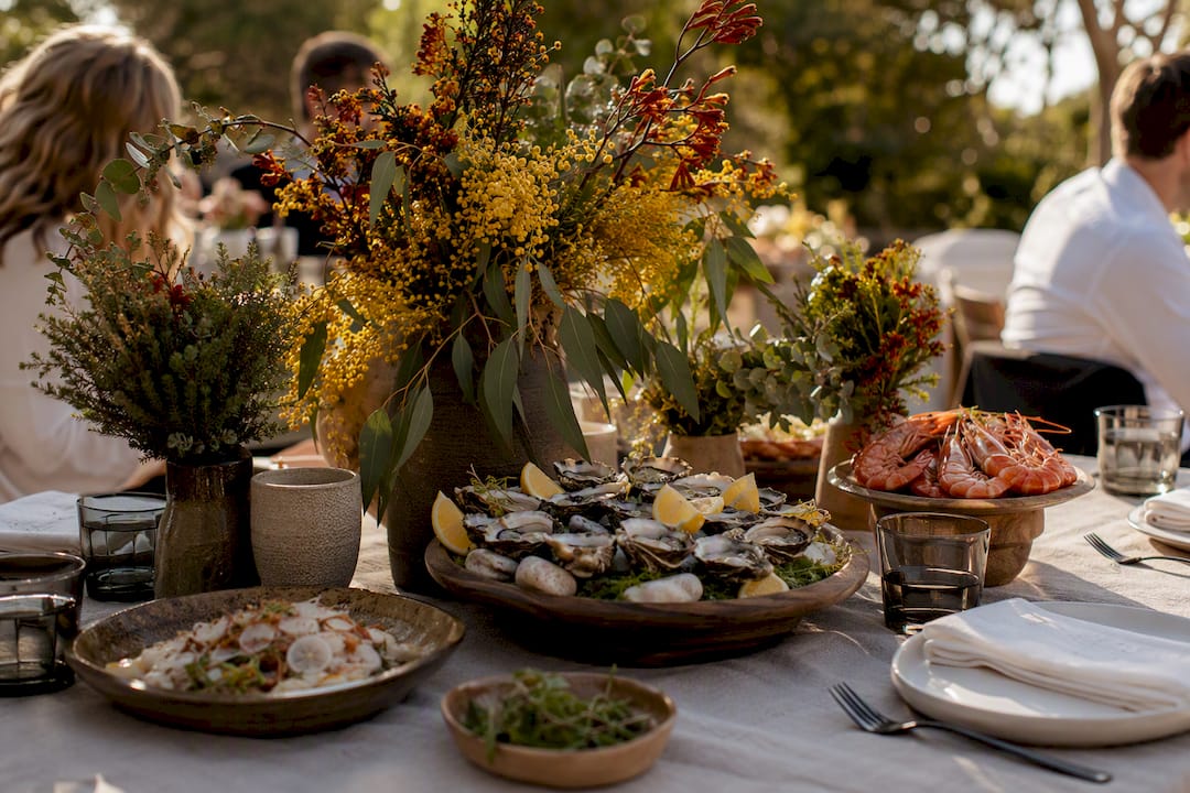 Destination weddings South Australia: venue ideas & planning checklist 3 Wedding reception table with local food and native flowers