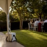 Backyard wedding marquee beside residential boundary
